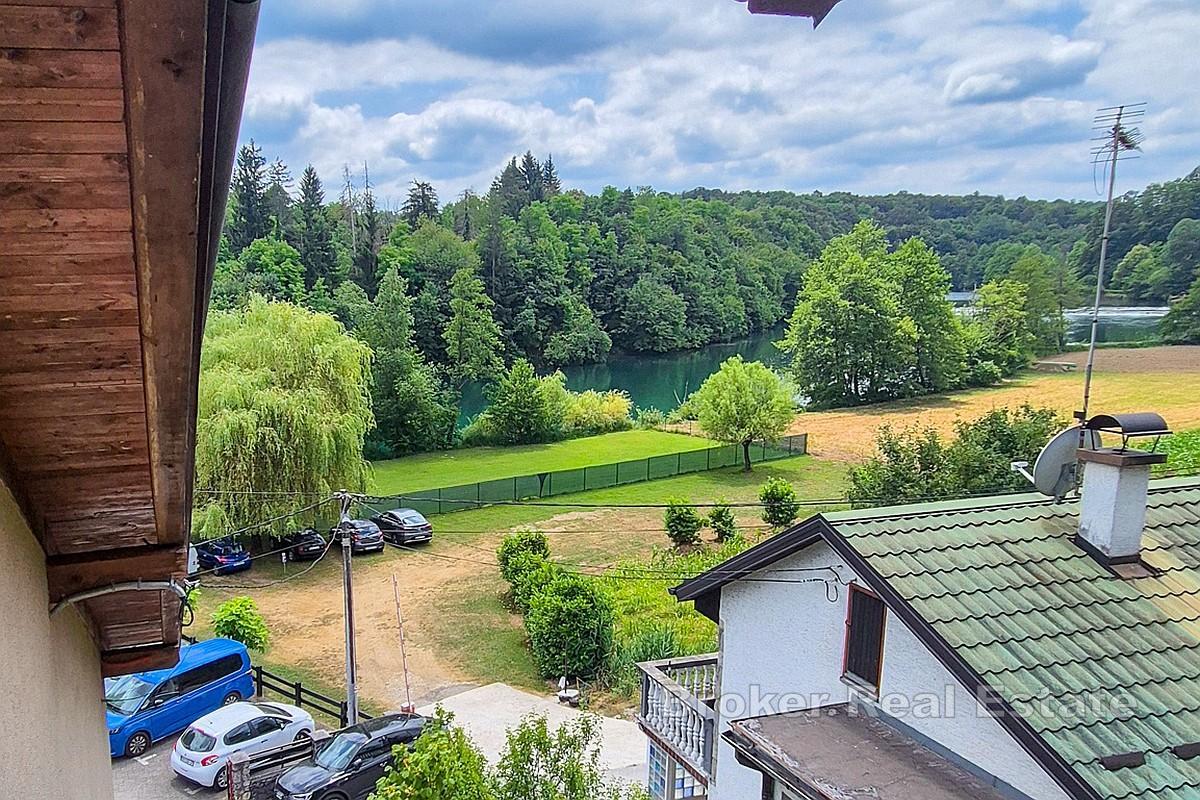 Maison entourée de verdure près de la rivière