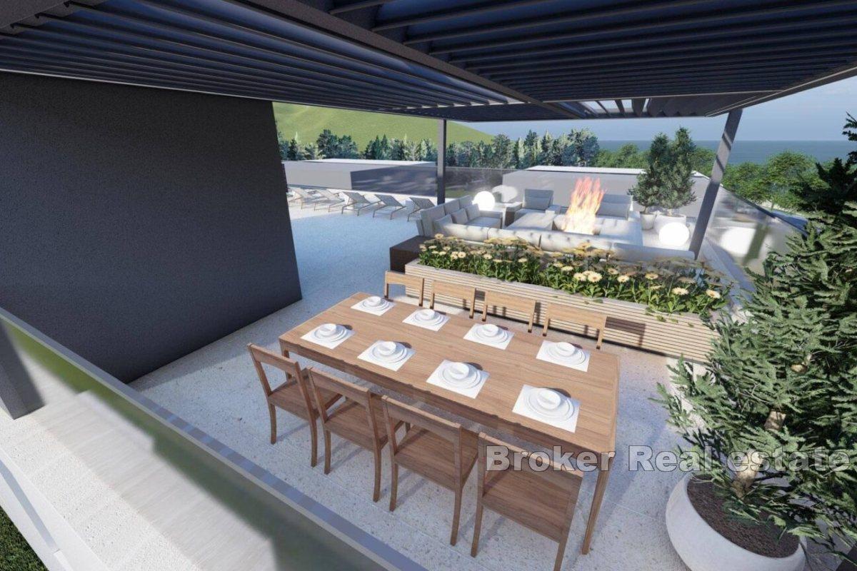 Nybygg med takterrasse i første rekke mot sjøen