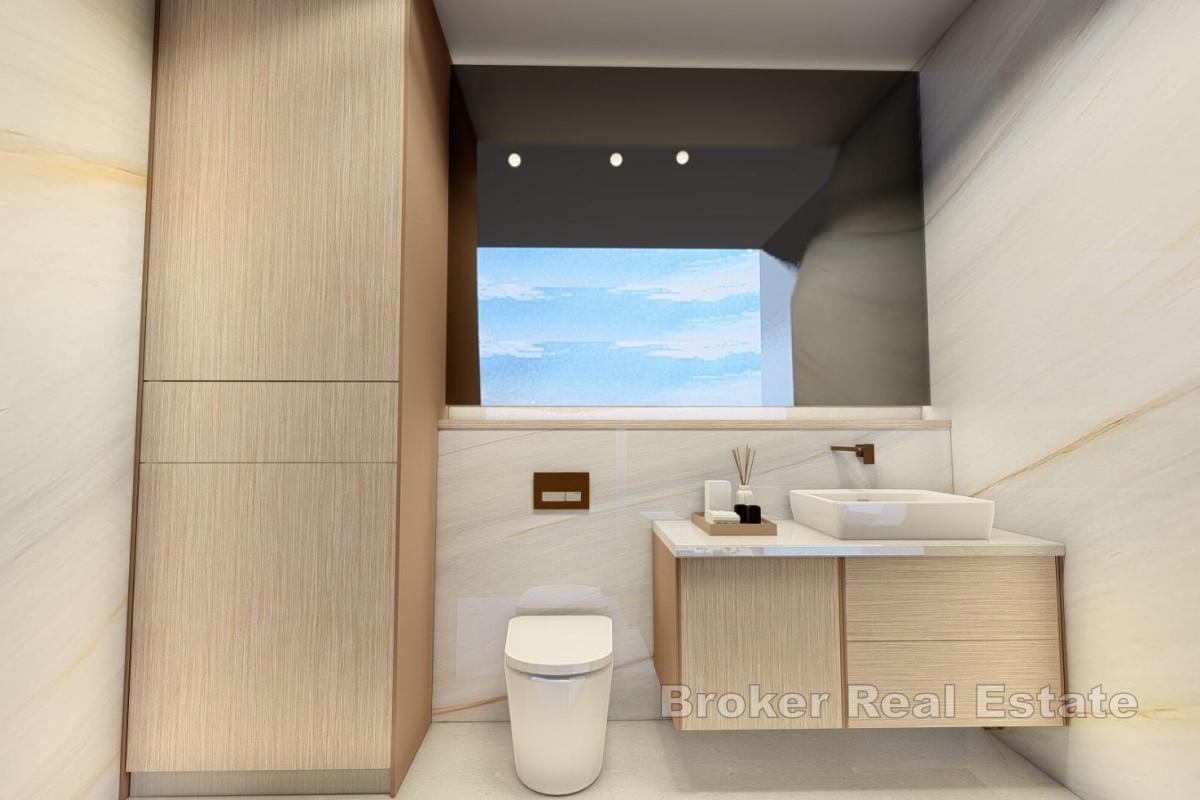 Moderni dvosobni apartman u novogradnji s djelomičnim pogledom na obalu